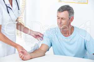 Doctor measuring arm with goniometer