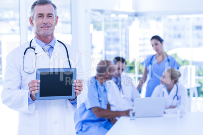 Doctor showing tablet pc during meeting