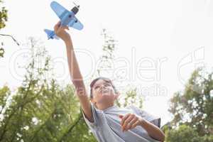 Boy playing with a toy plane at park