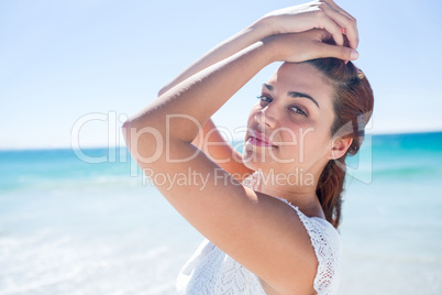 Pretty brunette relaxing beside the water