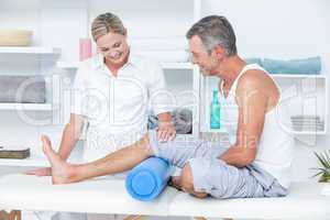 Doctor examining her patient leg