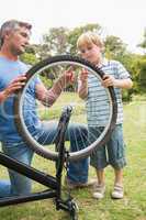 Father and his son fixing a bike