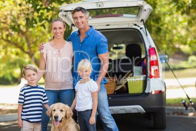 Happy family with their dog in the park