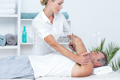 Doctor examining her patient arm