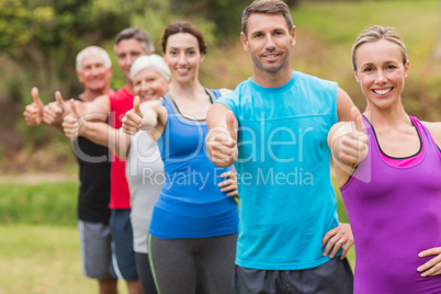 Happy athletic group with thumbs up