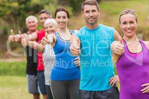 Happy athletic group with thumbs up