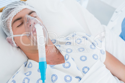 Patient lying with oxygen mask