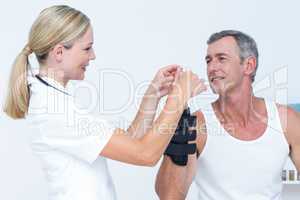 Doctor examining a man wrist