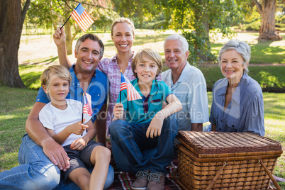 Happy family in the park and holding american flag