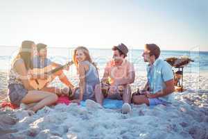 Happy hipsters relaxing and playing guitar