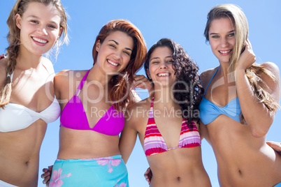 Beautiful women standing together arm around