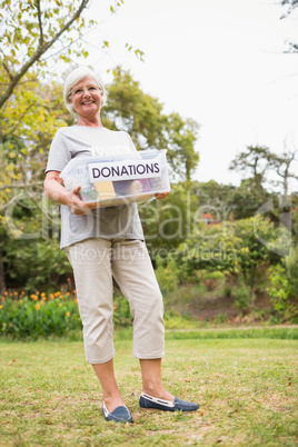 Happy grandmother holding donation box