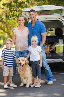 Happy family with their dog in the park