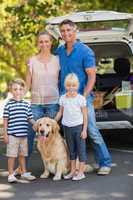 Happy family with their dog in the park