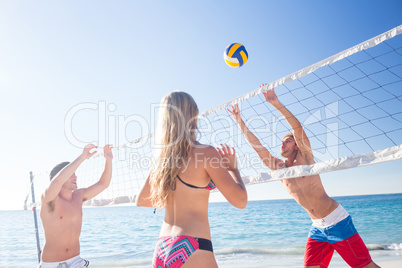 Group of friends playing volleyball