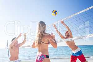 Group of friends playing volleyball