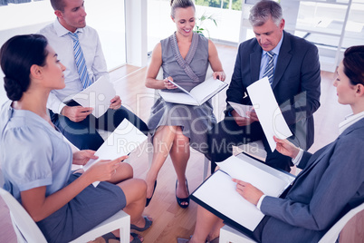 Business team sitting in circle and discussing