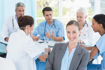 Male and female doctors working on reports