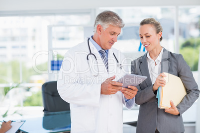 Confident doctor and pretty businesswoman discussing