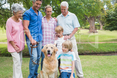 Happy family in the park with their dog