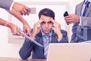 Worried businessman with head in hands