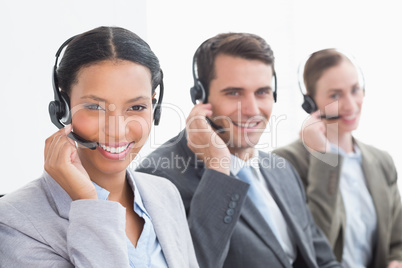 Business people with headsets using computers