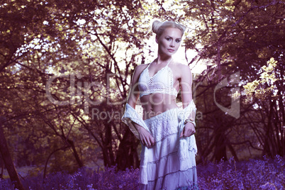 Artistic portrait of a girl in a bluebell forest