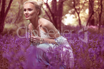 Artistic portrait of a girl in a bluebell forest