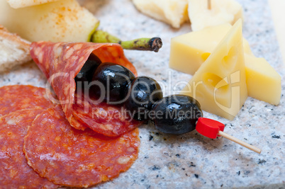 mix cold cut on a stone with fresh pears