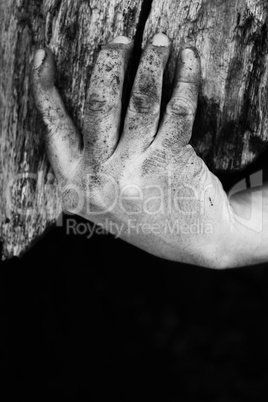 Dirty Hand Holding Weathered Wooden Planks