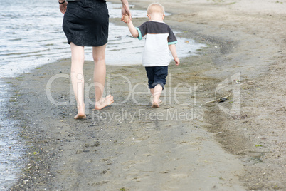 Mother and child walking along the beach