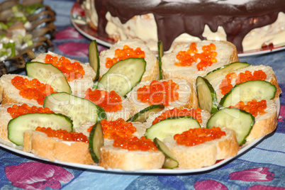 Sandwich with red caviar and cucumber