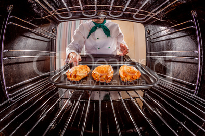 Chef cooking in the oven.