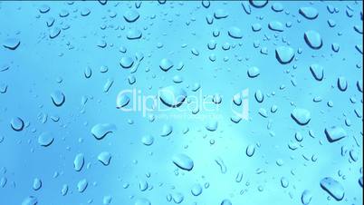 Raindrops against slow blue background