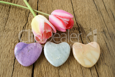 Three stone hearts and two tulips
