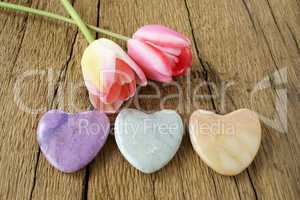 Three stone hearts and two tulips