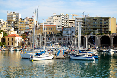 The yachts and motor boats are near pier, Crete, Greece