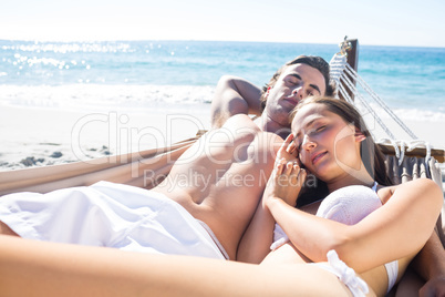 Happy couple napping together in the hammock