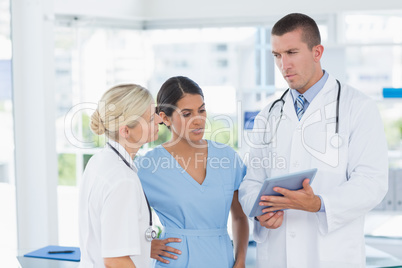 Doctors looking together at tablet