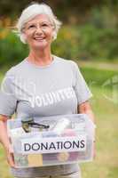 Happy grandmother holding donation box