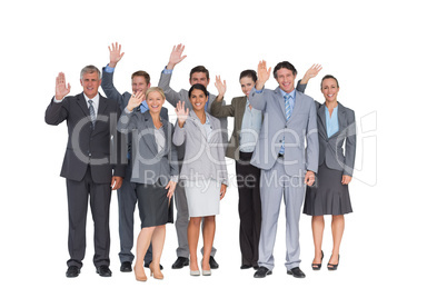 Smiling business team waving at camera