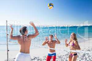 Group of friends playing volleyball