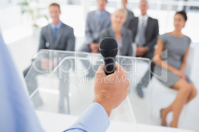 Businessman talking in microphone during conference