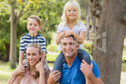 Happy family playing in the park together