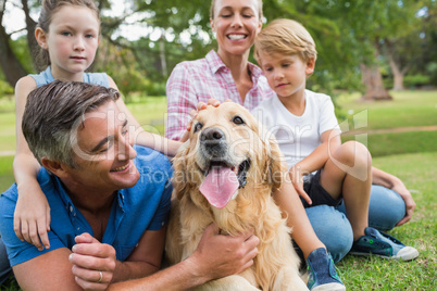 Happy family in the park with their dog