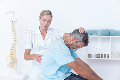 Doctor stretching a man back