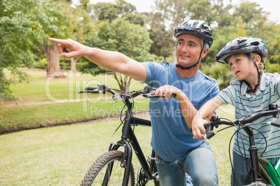 Happy father on a bike with his son