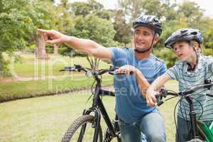 Happy father on a bike with his son