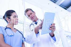 Nurse and doctor looking at tablet pc