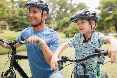 Happy father on a bike with his son